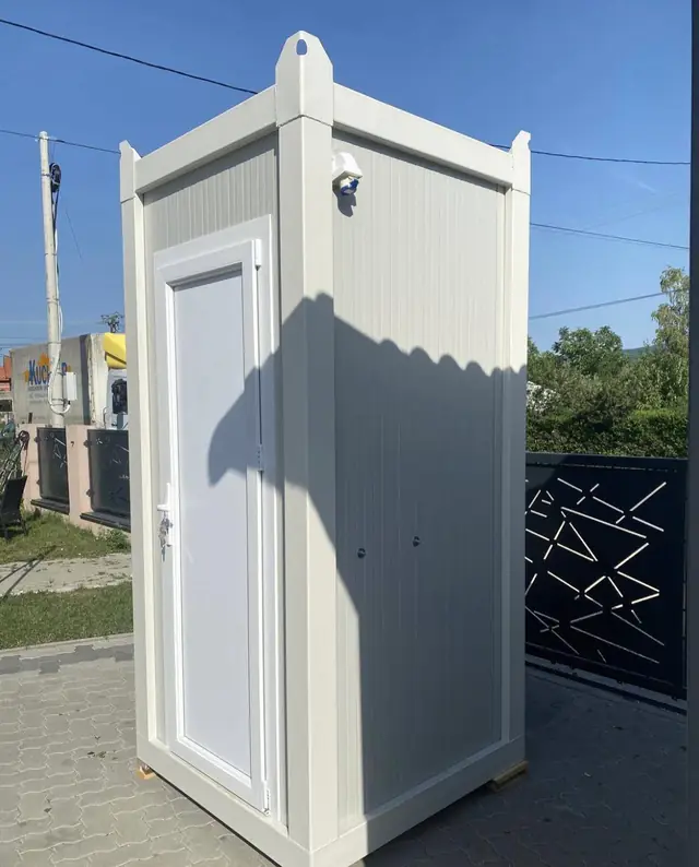 White single-room luxury restroom unit with a paneled door
